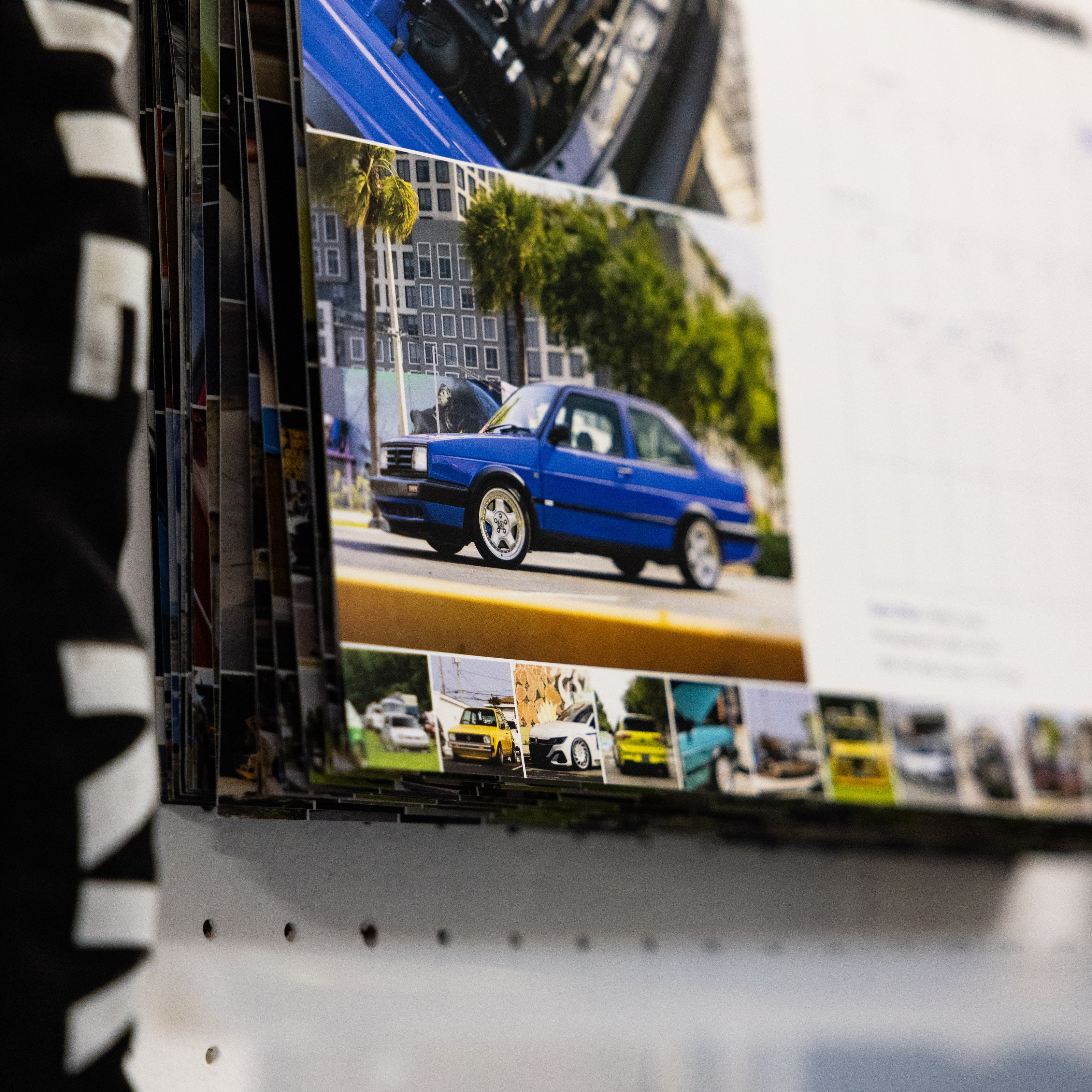 Close-up detail shot of the film strip of the 2026 VW Wall Calendar, featuring 13 different people, cars and dogs per spread from all over the USA.