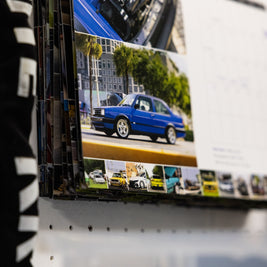 Close-up detail shot of the film strip of the 2026 VW Wall Calendar, featuring 13 different people, cars and dogs per spread from all over the USA.