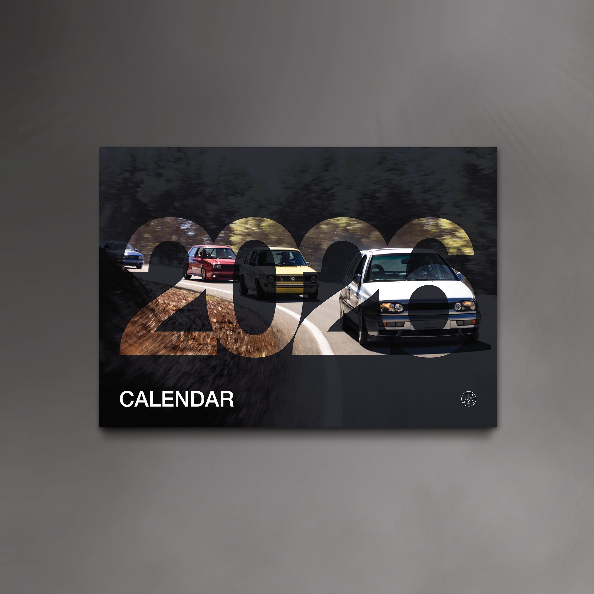 The cover of the 2026 VW Wall Calendar by Sam Dobbins and More Than More, featuring a rolling shot of a mk1, mk2 and mk3 VW Golfs in high gloss UV finish.